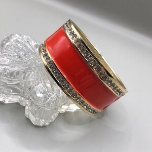 Gold tone enamel statement clamper bracelet.